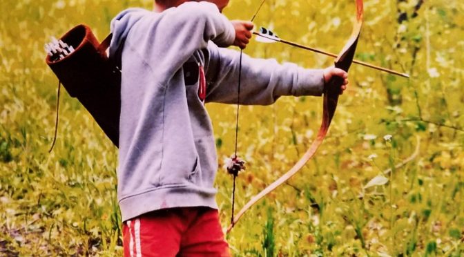Brad shooting his bow and arrow