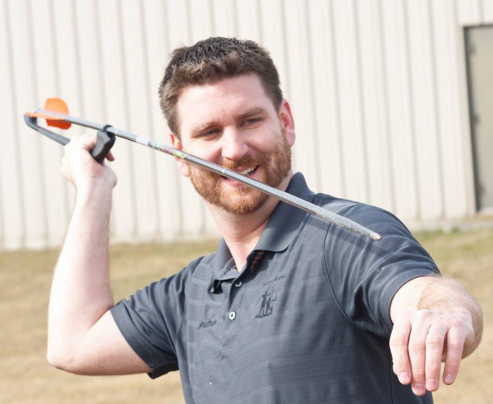 Person throwing an atlatl dart