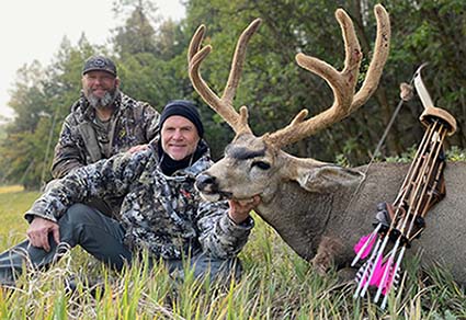 Client of a guided hunt with a beautiful buck Mule Deer
