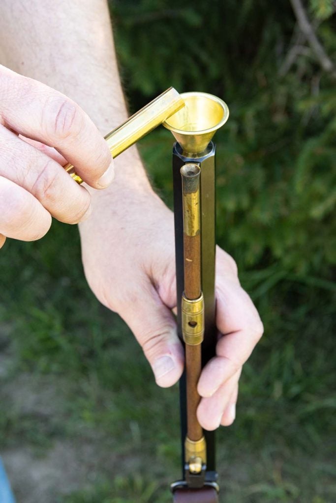 Carefully pour the powder in the muzzle using a funnel.