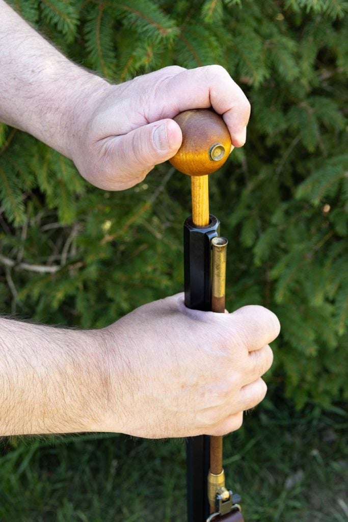 Using the long end of the ball starter push the projectile down a few inches.