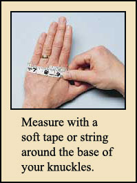 Measure with a soft tape or string around the base of your knuckles